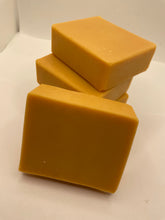 Three orange soap bars on a white background