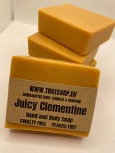 Stack of orange Juicy Clementine soap bars with  brown label on a white  background